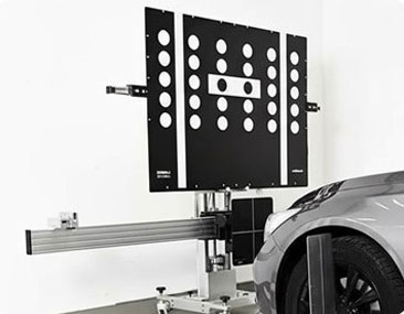 Static ADAS calibration with printed targets positioned at measured distances in front of a parked vehicle