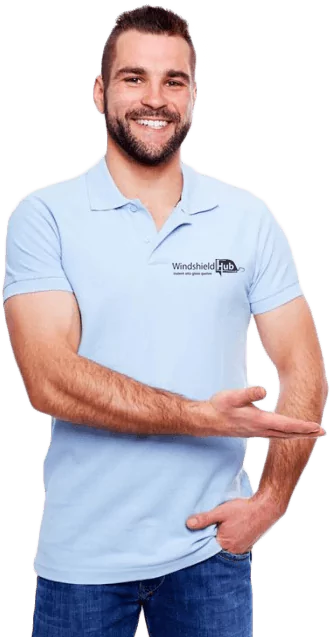 A man in a light blue polo shirt with WindshieldHUB logo smiles and points to the right. mobile service2.webp